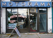 Sign over restaurant read MOTORAMA in widely-spaced, illuminated letters